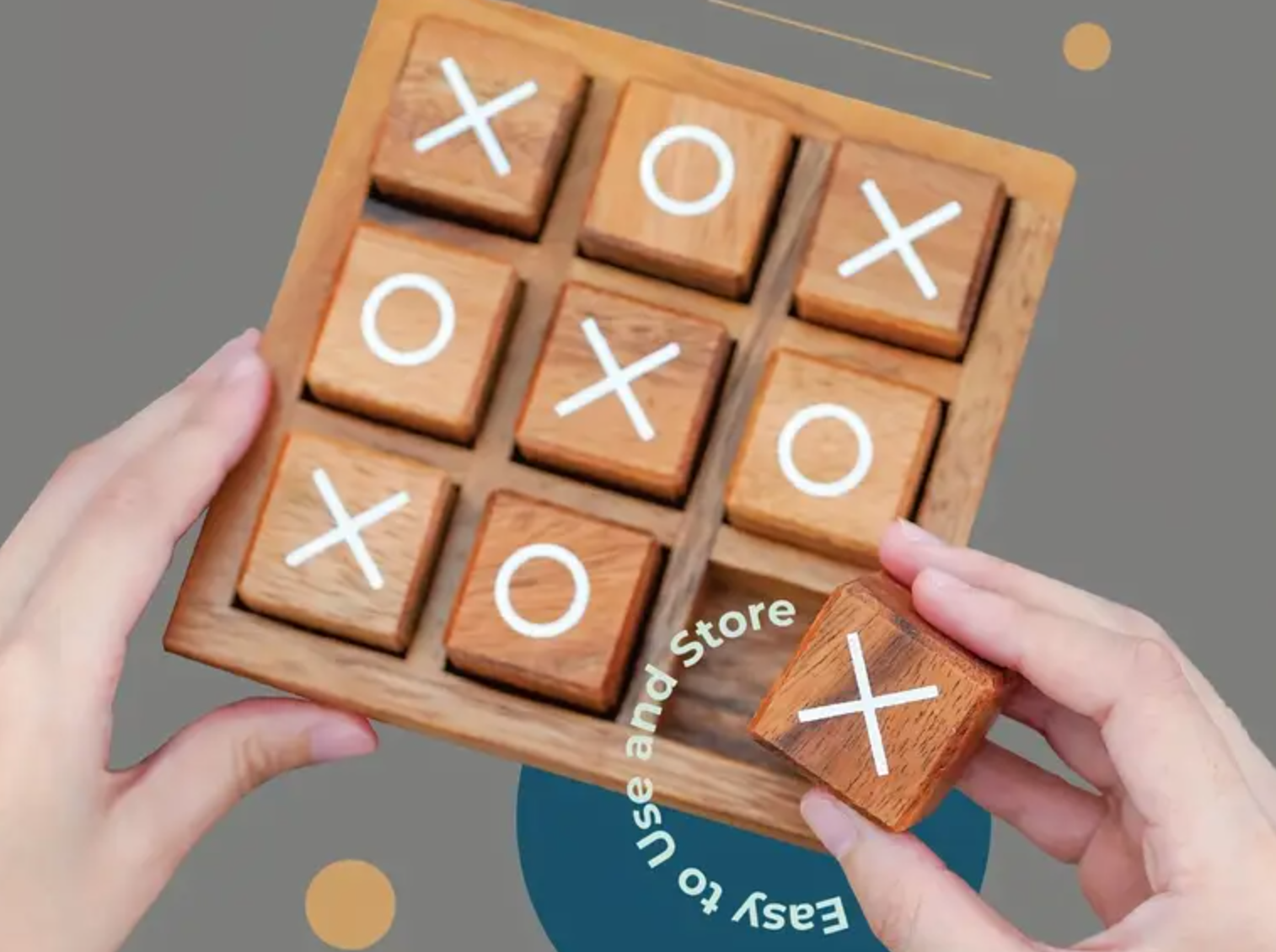 Wooden tic-tac-toe game with hands holding it against a grey background